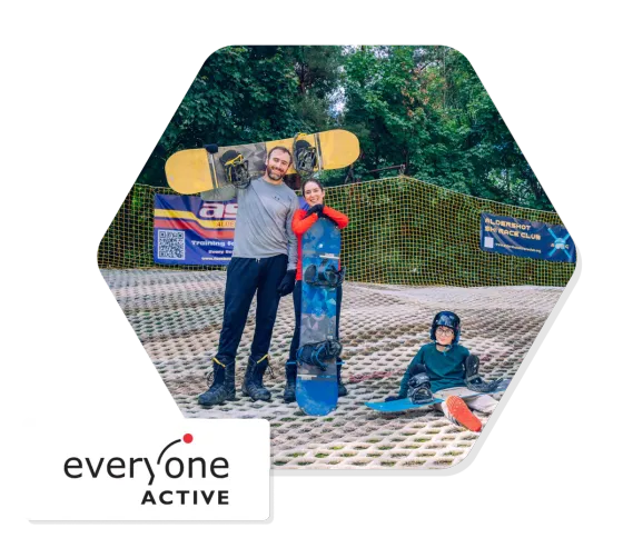 Two instructors and a young snowboarder on the dry slope at Alpine Snowsports Aldershot, an Everyone Active centre