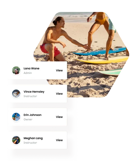 An instructor coaching a learner on the sand, beside eola’s list of team members with their roles