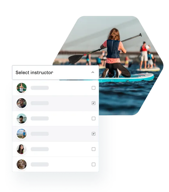 A paddleboarder kneeling on a board in a group session, beside an eola list for picking the session’s instructors