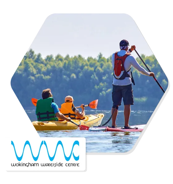 Two kayakers and a paddleboarder on the water at Wokingham Waterside Centre, with the centre’s logo